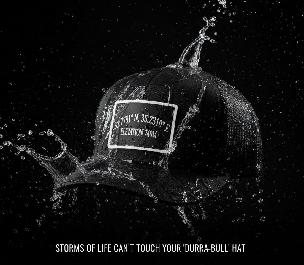 Black cap with a label splashed with water on a black background, featuring text and 'Broken to Risen Apparel' branding.